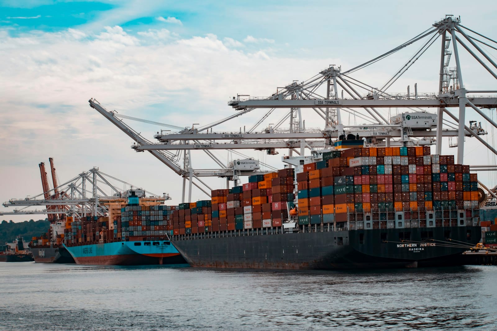 Container port cranes and cargo operations at sunset